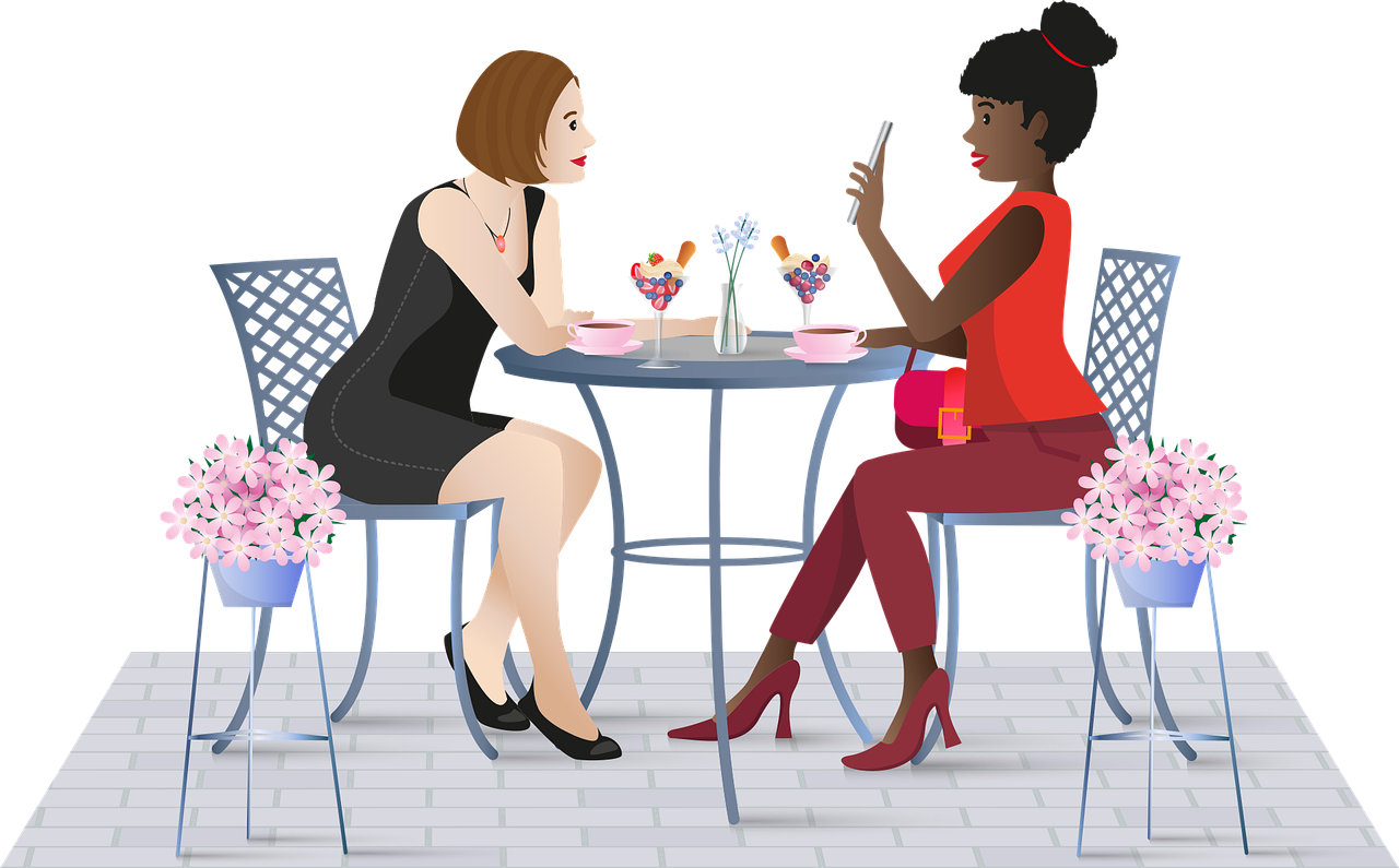 Two women sat at a table and having a conversation.